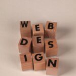 Wooden blocks arranged to spell 'Web Design'. Perfect for creative, digital content themes.