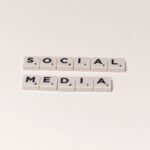 Scrabble tiles spelling 'social media' on a white background, representing digital communication concepts.